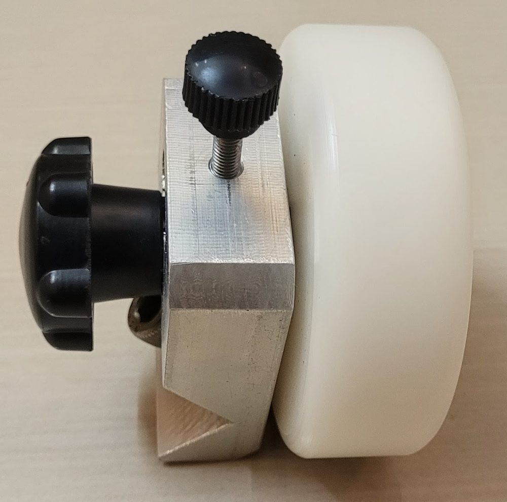 Nylon guide wheel mounted in a machined aluminium bracket