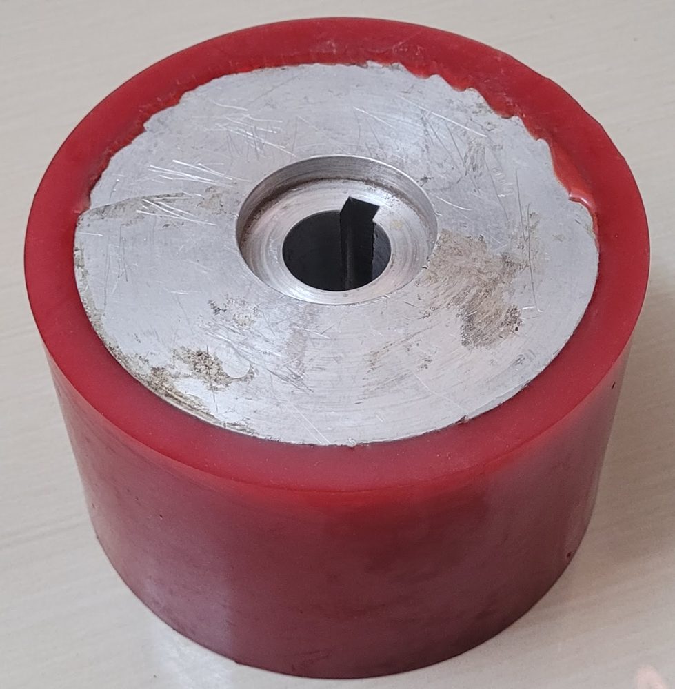 Red polyurethane drive roller on an aluminium hub