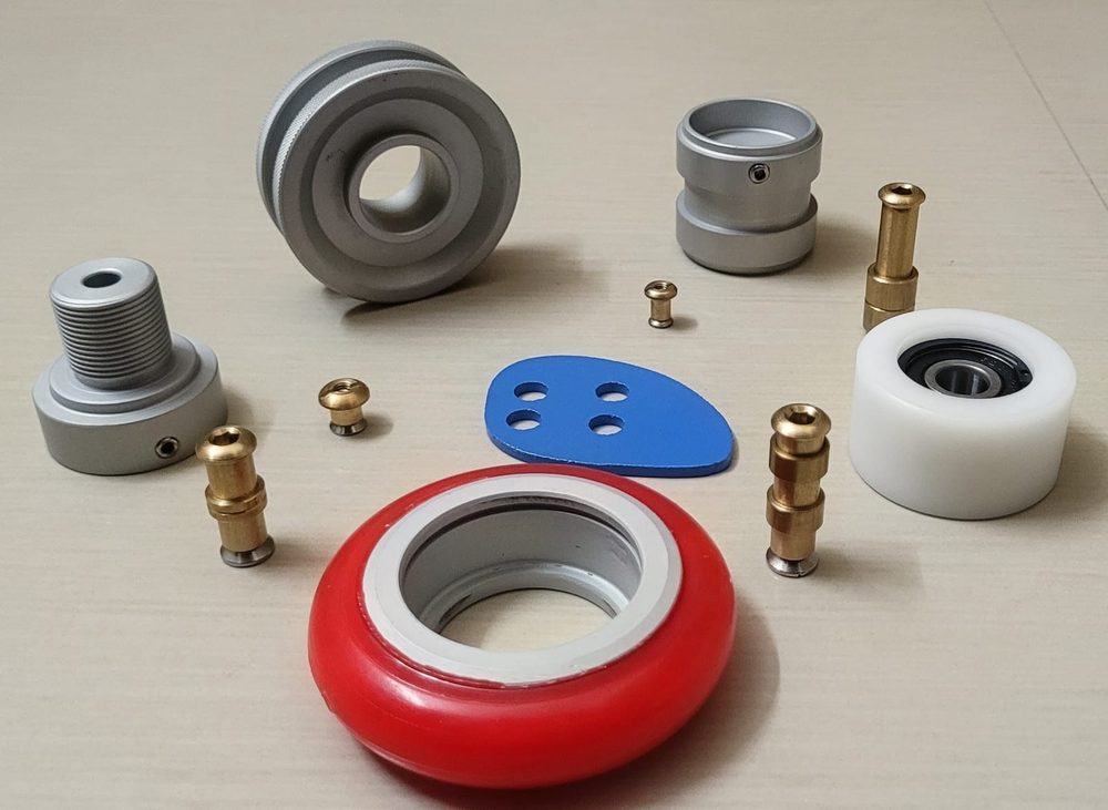 An assortment of SEW spares — rollers, wheels, bushes and fittings