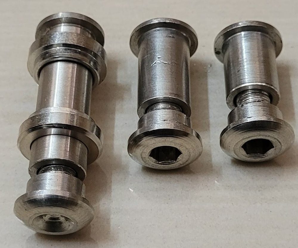 Three machined steel stepped spindles